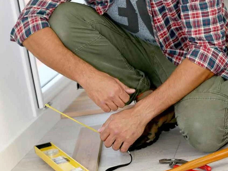 person installing floors in a home